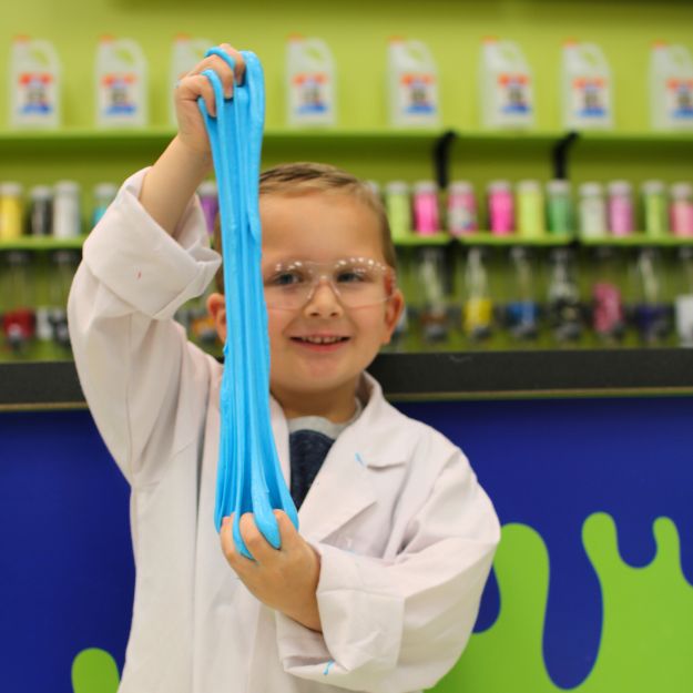 Child showcasing slime they created at the STEAM entertainment museum