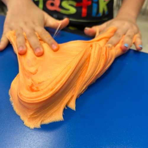 Kid making and playing with colorful slime at Funtastik Labs