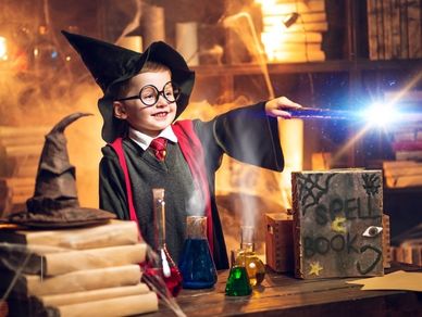 Kid Making a magic wand and spell book at summer camp